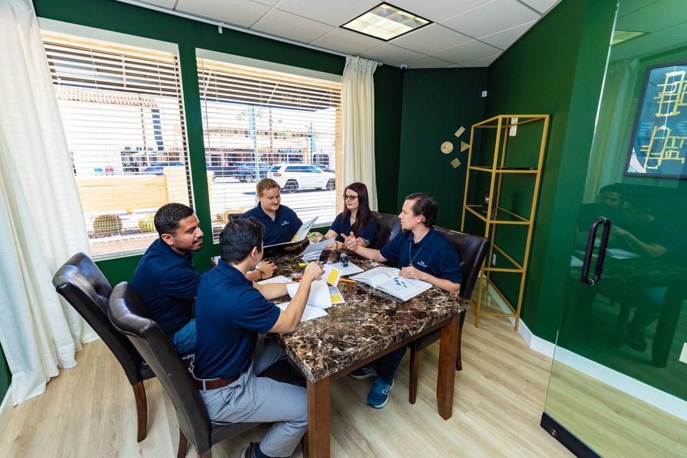 Bean Counter staff reviewing documents together around a conference table
